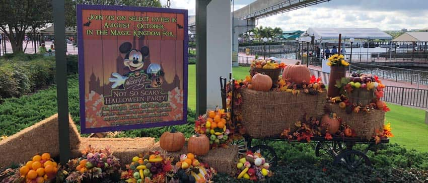 Sign at Magic Kingdom announcing Mickey's Not-So-Scary-Halloween Party with Halloween decorations around it.