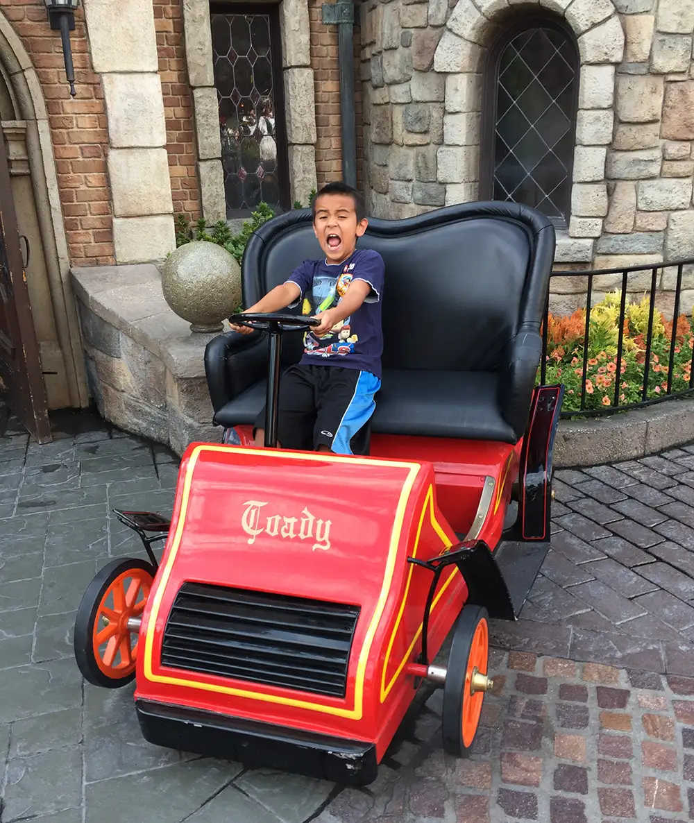 Grandkid riding Mr. Toad's Wild Ride.